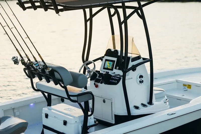 Slide: The Image of 2023 NauticStar 227 Bay boat with fishing rods and helm console. - 17