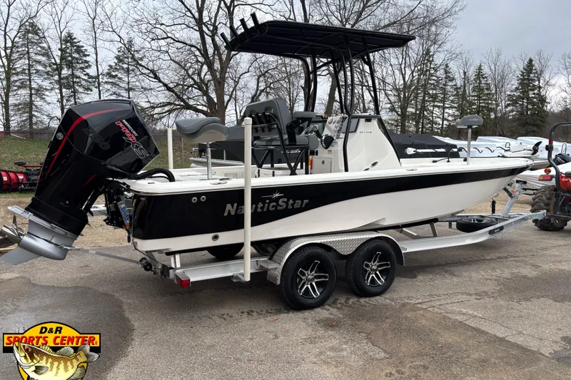 Slide: The Image of 2023 NauticStar 227 Bay boat on trailer, featuring powerful outboard motor. - 20