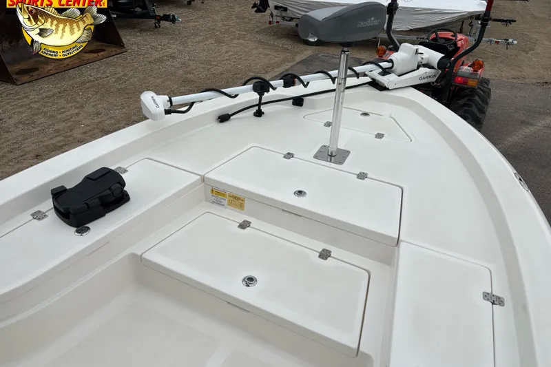 Slide: The Image of 2023 NauticStar 227 Bay boat deck with Garmin trolling motor and storage compartments. - 25