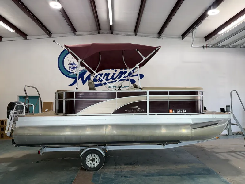The Image of 2016 Bennington 20SLX pontoon boat in a storage facility. - 1