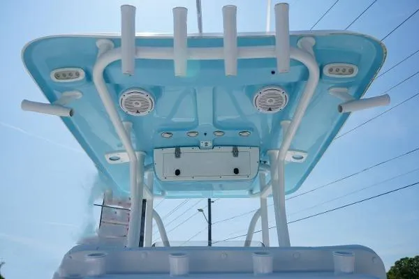 Slide: The Image of 2018 Sea Hunt Ultra 225 boat docked by waterfront home, clear blue sky. - 10