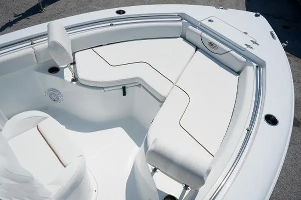 Slide: The Image of 2018 Sea Hunt Ultra 225 boat with white cushioned seating and sleek design. - 24