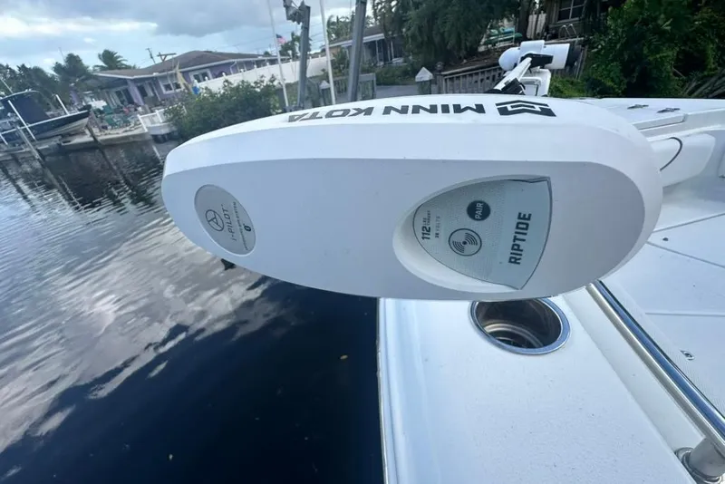 Slide: The Image of Minn Kota Riptide motor on 2018 Sea Hunt Ultra 225 boat by the water. - 29