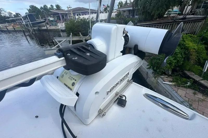 Slide: The Image of Minn Kota motor on 2018 Sea Hunt Ultra 225 boat docked by waterfront homes. - 30