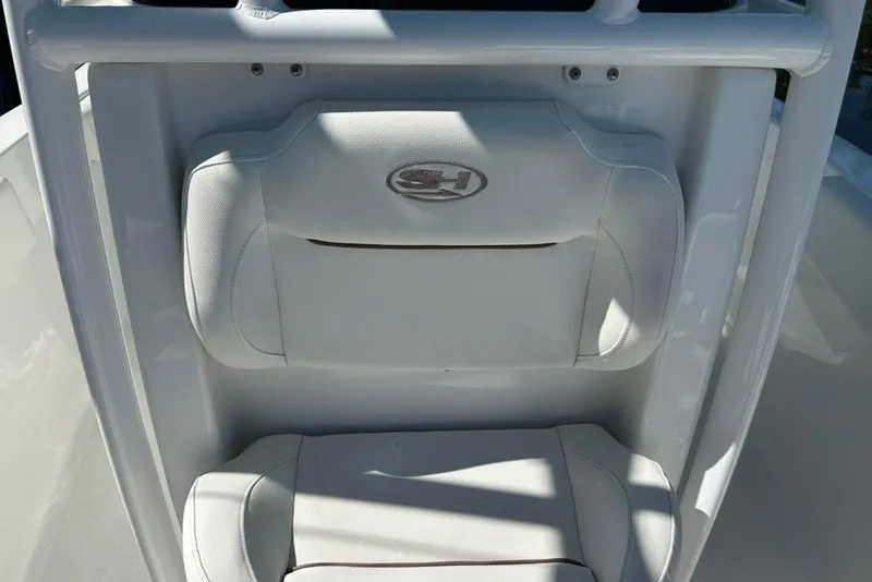 Slide: The Image of 2018 Sea Hunt Ultra 225 boat seat with logo, featuring white cushioned design. - 39