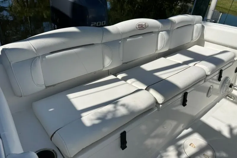 Slide: The Image of 2018 Sea Hunt Ultra 225 boat with white cushioned seating and Yamaha 200 engine. - 43