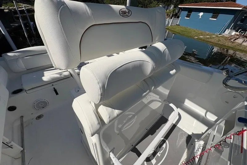 Slide: The Image of 2018 Sea Hunt Ultra 225 boat interior with white cushioned seating and helm. - 45