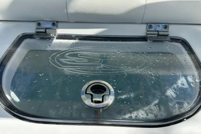 Slide: The Image of Close-up of a 2018 Sea Hunt Ultra 225 boat compartment with water droplets. - 48