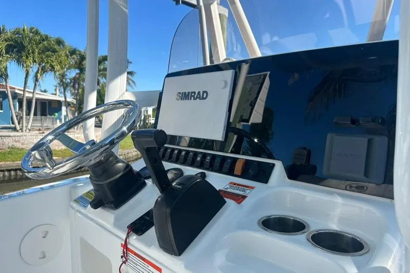 Slide: The Image of 2018 Sea Hunt Ultra 225 boat console with steering wheel and Simrad display. - 50