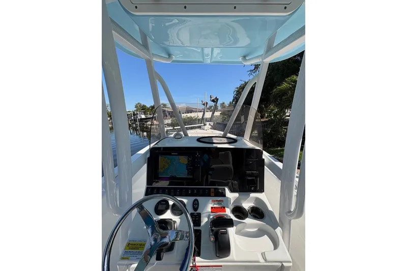 Slide: The Image of 2018 Sea Hunt Ultra 225 boat dashboard with steering wheel and navigation system. - 51