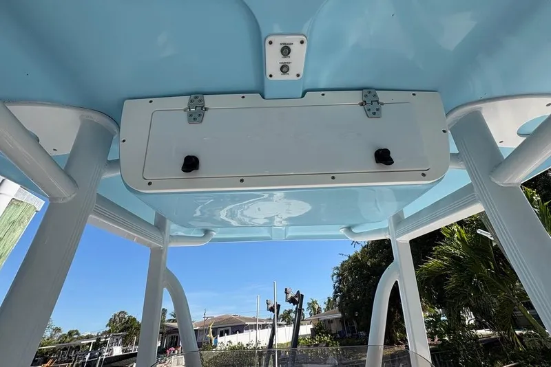 Slide: The Image of 2018 Sea Hunt Ultra 225 boat T-top with storage compartment and control panel. - 52