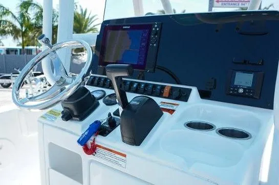 Slide: The Image of Control panel of a 2018 Sea Hunt Ultra 225 boat with steering wheel and navigation system. - 55