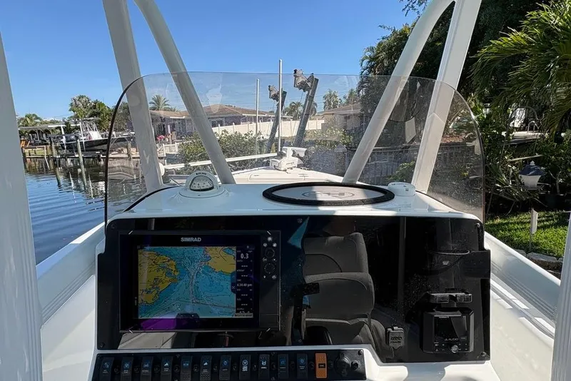 Slide: The Image of 2018 Sea Hunt Ultra 225 boat dashboard with navigation system and clear windshield. - 56