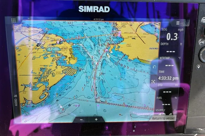 Slide: The Image of Simrad marine GPS display on 2018 Sea Hunt Ultra 225, showing nautical chart and navigation data. - 58