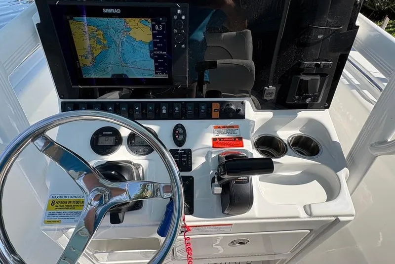 Slide: The Image of 2018 Sea Hunt Ultra 225 boat dashboard with steering wheel and navigation system. - 59