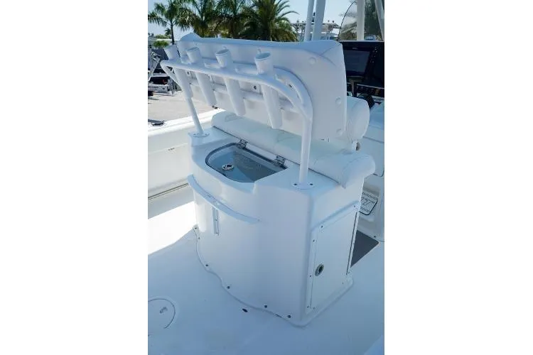 Slide: The Image of 2018 Sea Hunt Ultra 225 boat docked on a calm waterway near a house. - 6