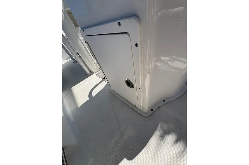 Slide: The Image of 2018 Sea Hunt Ultra 225 boat interior, featuring a sleek white compartment door. - 63