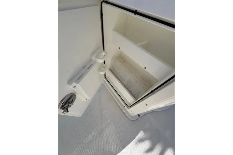 Slide: The Image of Open storage compartment on a 2018 Sea Hunt Ultra 225 boat. - 64