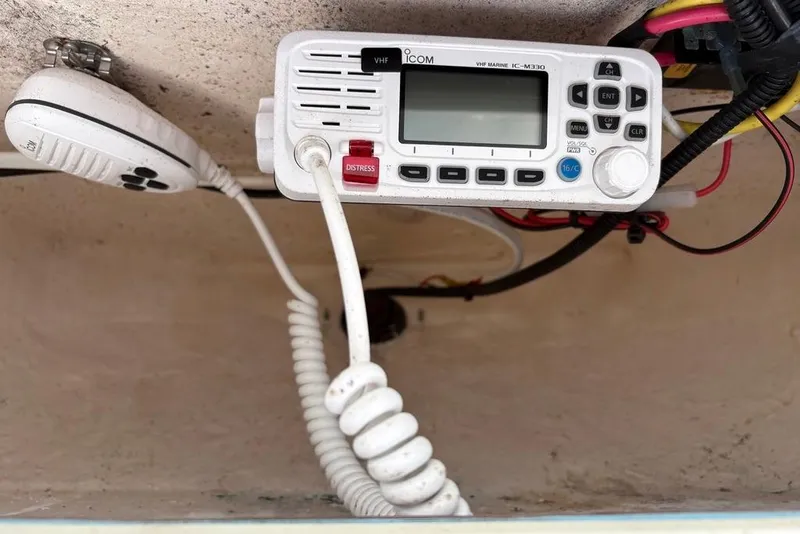 Slide: The Image of VHF marine radio on 2018 Sea Hunt Ultra 225 boat, featuring distress button and microphone. - 66