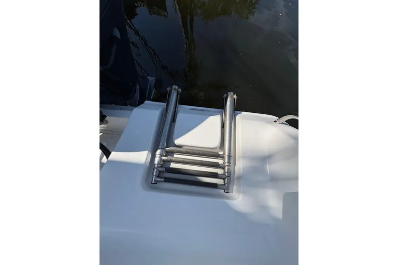 Slide: The Image of Stainless steel boat ladder on 2018 Sea Hunt Ultra 225, near water. - 71