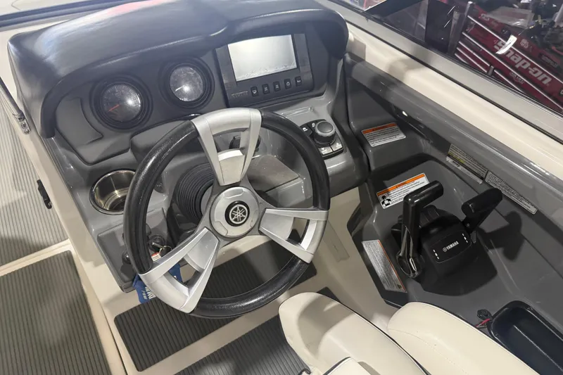 Slide: The Image of Cockpit of 2015 Yamaha Boats AR240 HO with steering wheel and control panel. - 4