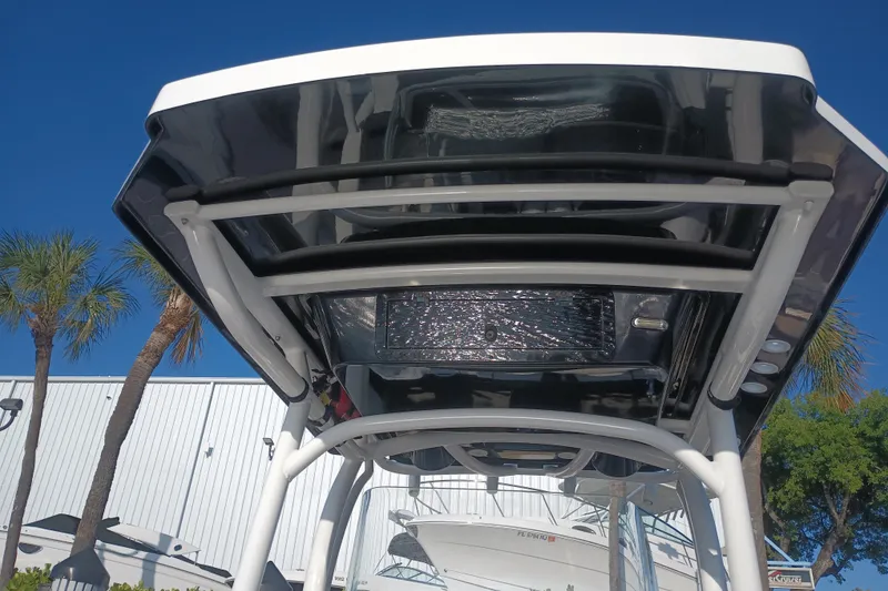 Slide: The Image of 2019 Wellcraft 242 Scarab Offshore boat interior with seating and table, docked by water. - 12