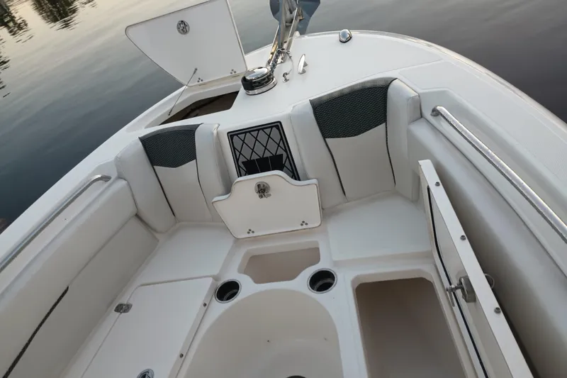 Slide: The Image of 2019 Wellcraft 242 Scarab Offshore boat dashboard with steering wheel and navigation screens. - 16