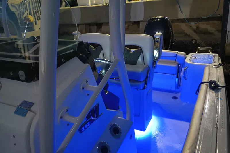 Slide: The Image of 2019 Wellcraft 242 Scarab Offshore boat interior with dual seats and steering wheel. - 22