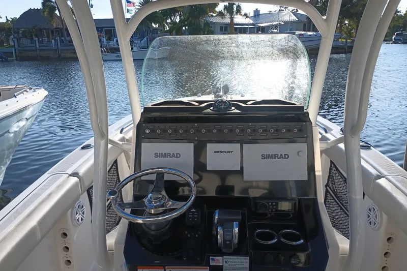 Slide: The Image of 2019 Wellcraft 242 Scarab Offshore boat interior with seating and storage features. - 23