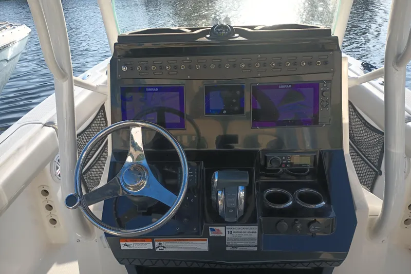 Slide: The Image of 2019 Wellcraft 242 Scarab Offshore boat interior with seating and storage compartments. - 24