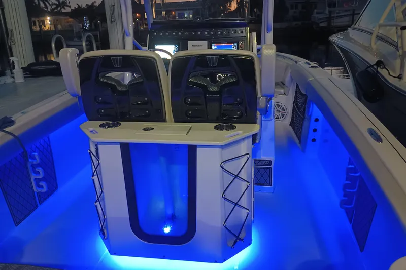 Slide: The Image of 2019 Wellcraft 242 Scarab Offshore boat interior with blue LED lighting. - 25