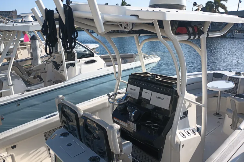 Slide: The Image of 2019 Wellcraft 242 Scarab Offshore boat stern view at dock. - 28