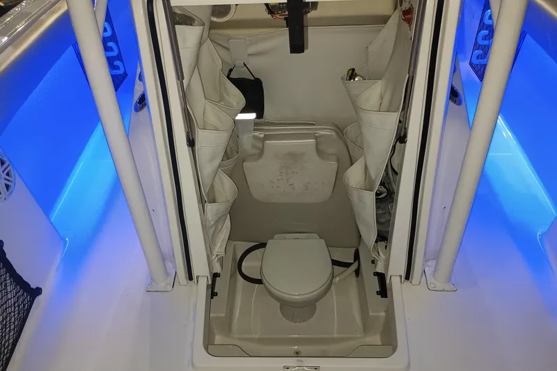 Slide: The Image of 2019 Wellcraft 242 Scarab Offshore boat roof with speakers and rod holders against blue sky. - 9