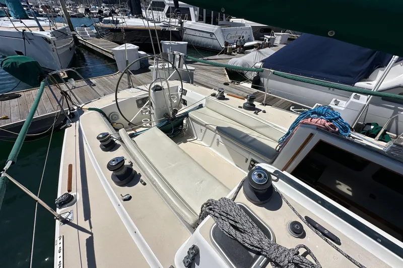 Slide: The Image of 1996 J Boats J/120 sailboat cockpit with winches and ropes, docked at marina. - 22