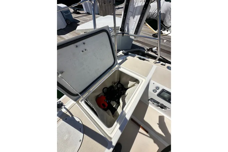 Slide: The Image of Open storage compartment on 1996 J Boats J/120 sailboat deck, showing equipment inside. - 28