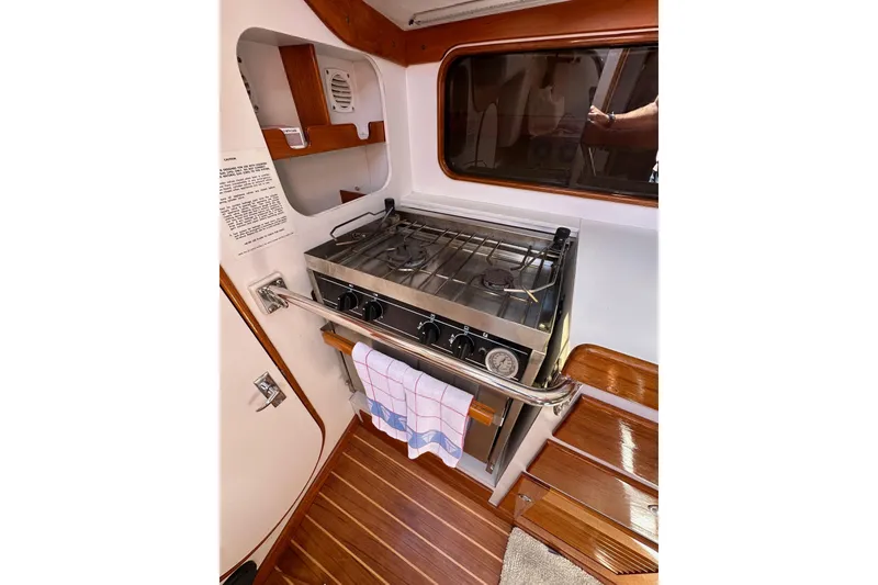 Slide: The Image of 1996 J Boats J/120 yacht interior kitchen with stove and wooden flooring. - 38