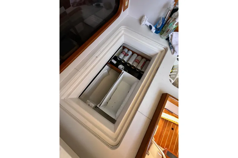Slide: The Image of Interior view of a 1996 J Boats J/120, featuring a built-in cooler with beverages. - 40