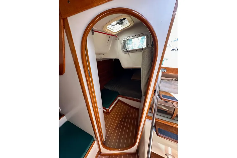 Slide: The Image of Interior view of 1996 J Boats J/120 sailboat cabin with wooden trim and seating. - 44