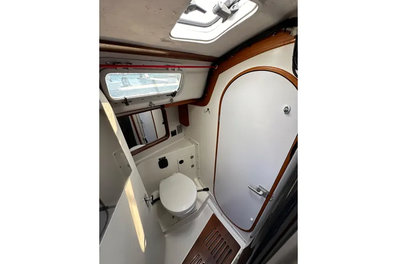 Slide: The Image of Interior of 1996 J Boats J/120 sailboat bathroom with toilet and porthole. - 67