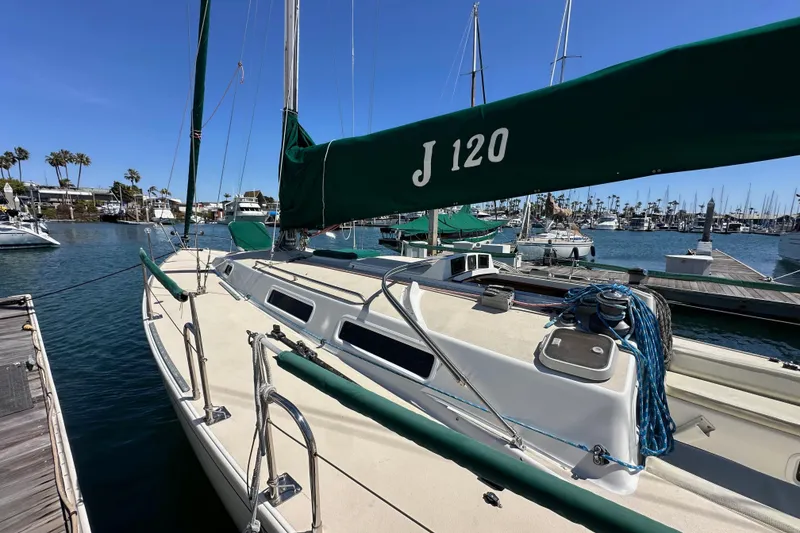 Slide: The Image of 1996 J Boats J/120 sailboat docked in a marina under clear blue skies. - 7