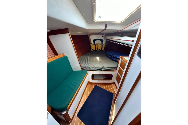 Slide: The Image of Interior of 1996 J Boats J/120 sailboat with cozy cabin and wooden accents. - 73