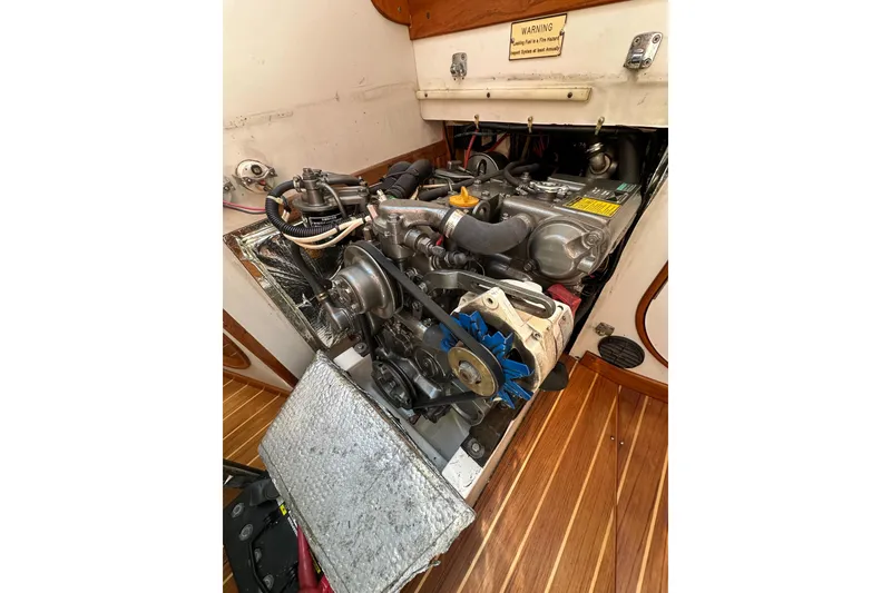 Slide: The Image of Engine compartment of a 1996 J Boats J/120 sailboat, showcasing mechanical components. - 87