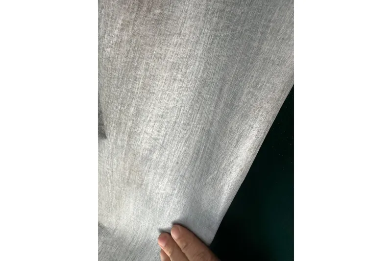Slide: The Image of Hand holding sailcloth from a 1996 J Boats J/120 yacht. - 98