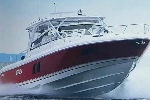 The Image of 2020 Intrepid 475 Sport Yacht cruising on water, showcasing sleek red and white design. - 0