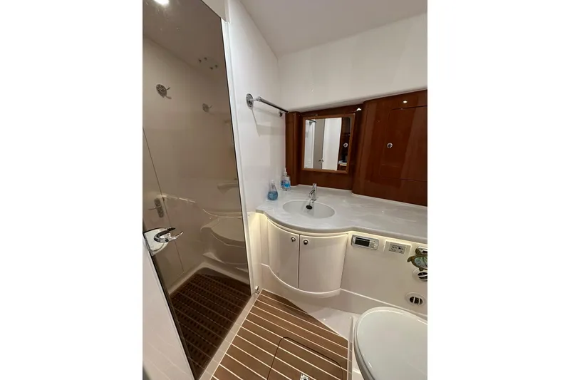 Slide: The Image of Luxurious bathroom in 2020 Intrepid 475 Sport Yacht with modern fixtures and wooden accents. - 10