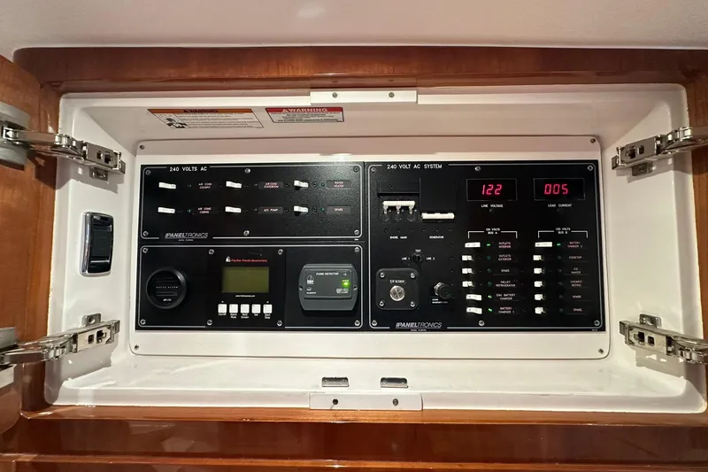 Slide: The Image of Control panel of a 2020 Intrepid 475 Sport Yacht, featuring 240-volt AC system. - 12