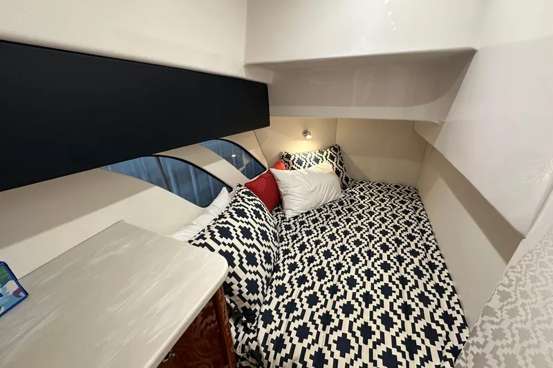 Slide: The Image of Cozy cabin interior of 2020 Intrepid 475 Sport Yacht with geometric bedding and ambient lighting. - 13