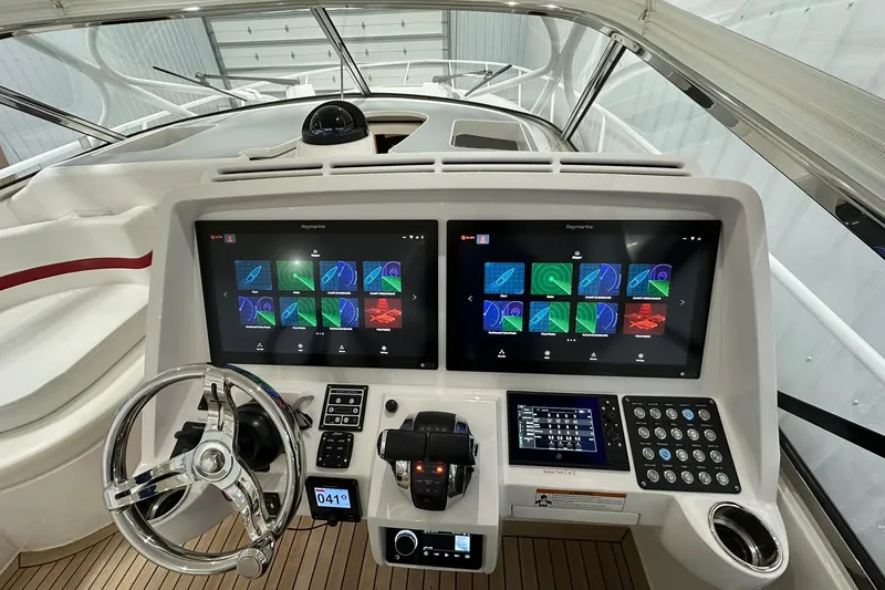 Slide: The Image of Helm of 2020 Intrepid 475 Sport Yacht with advanced navigation displays and controls. - 16