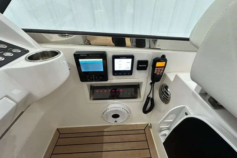 Slide: The Image of 2020 Intrepid 475 Sport Yacht dashboard with navigation and communication equipment. - 17