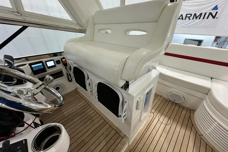 Slide: The Image of Helm of 2020 Intrepid 475 Sport Yacht with white seating and modern controls. - 18